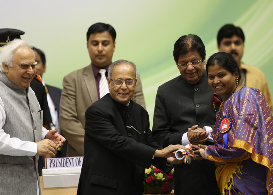 The President of India, Shri Pranab Mukherjee presenting an award to a teacher in New Delhi on September 5, 2012 at the function for the presentation of the National Awards to Teachers. Also seen (from left to right) are the Union Minister of Human Resour