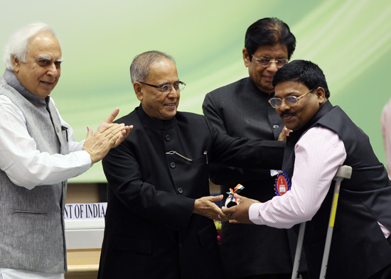 The President of India, Shri Pranab Mukherjee presenting an award to a teacher in New Delhi on September 5, 2012 at the function for the presentation of the National Awards to Teachers. Also seen (from left to right) are the Union Minister of Human Resour
