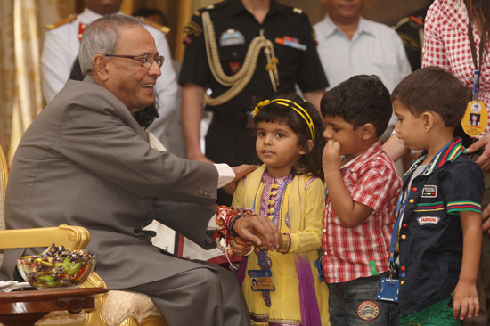 Children tying 'Rakhi' on the President of India, Shri Pranab Mukherjee, at Rashtrapati Bhavan on August 2, 2012 on the occasion of Raksha Bandhan.
