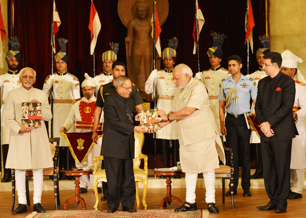 The President of India, Shri Pranab Mukherjee receiving first copy of the ‘Indradhanush’ from the Prime Minister of India, Shri Narendra Modi at Rashtrapati Bhavan in New Delhi on July 25, 2014. Also seen is the Vice President of India, Shri Hamid Ansari. 